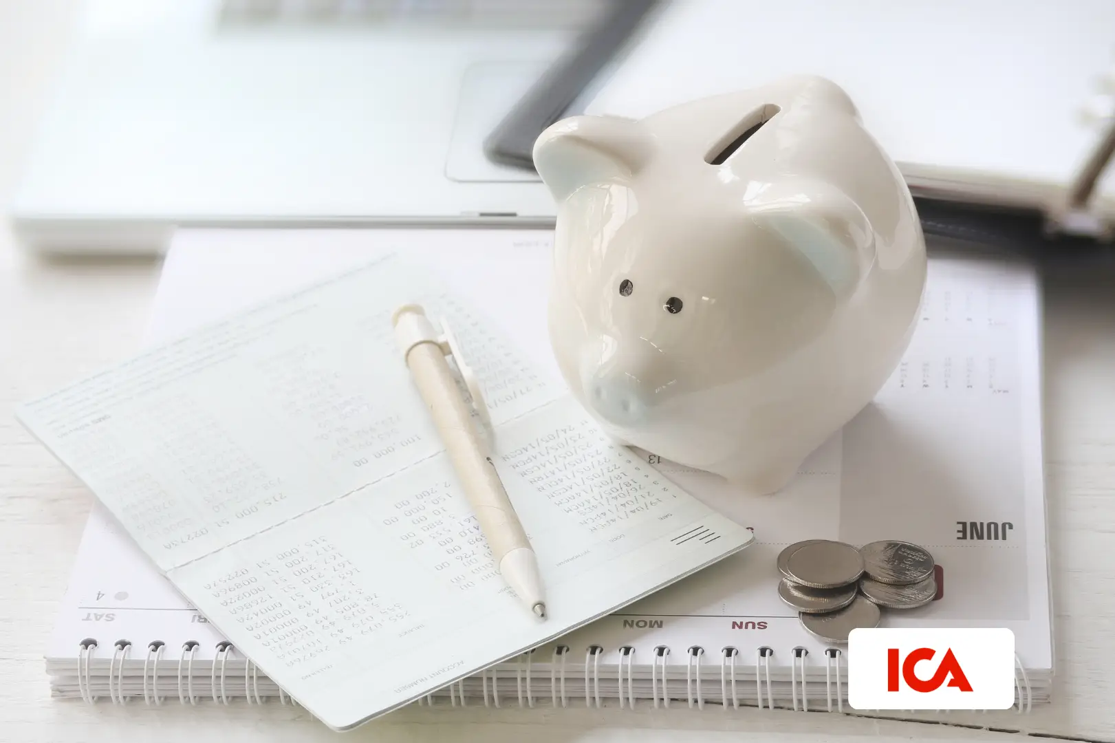 Kid playing with a saving pig and coins on the floor.