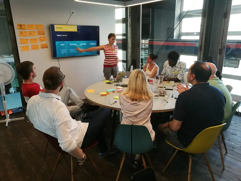 A person having a presentation for the team, showing slides on a monitor.